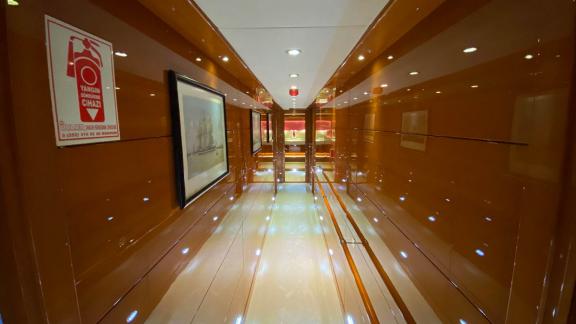 Shiny hallway with lighting and artworks on yacht Gül Maria